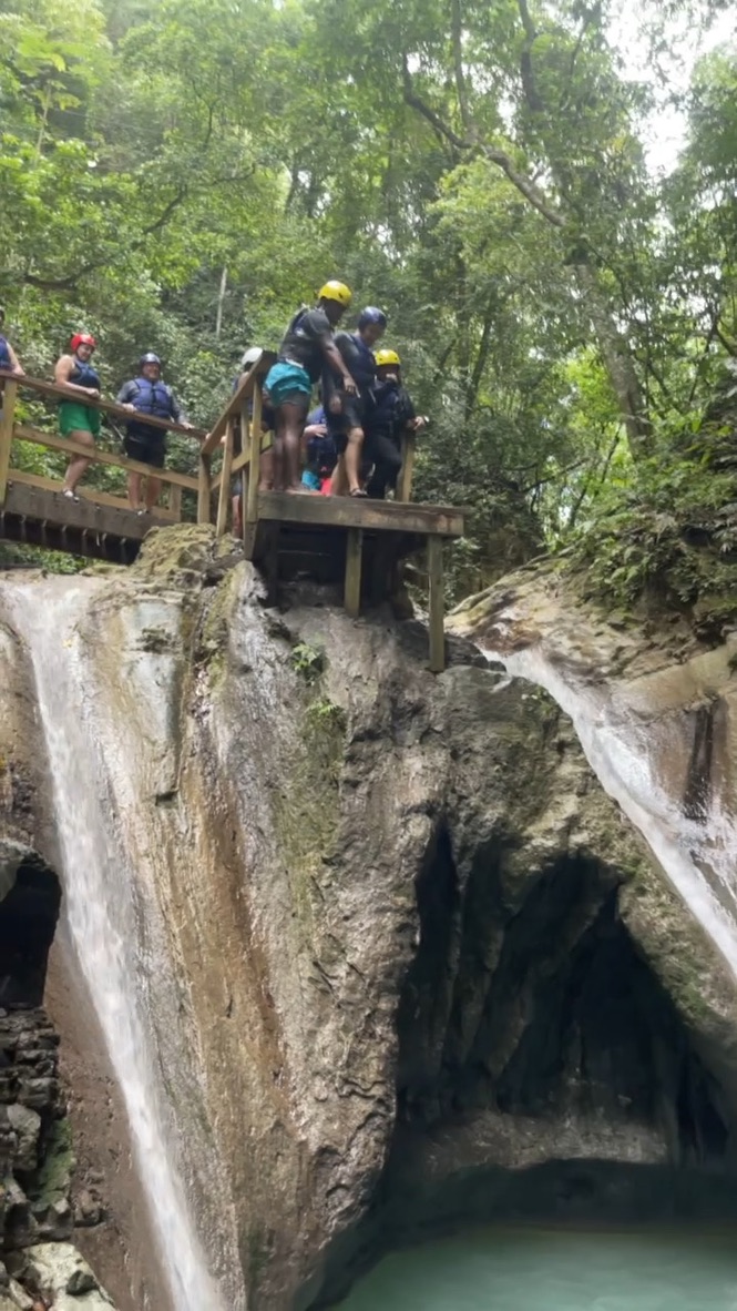 Jumping into waterfall pool Damajagua